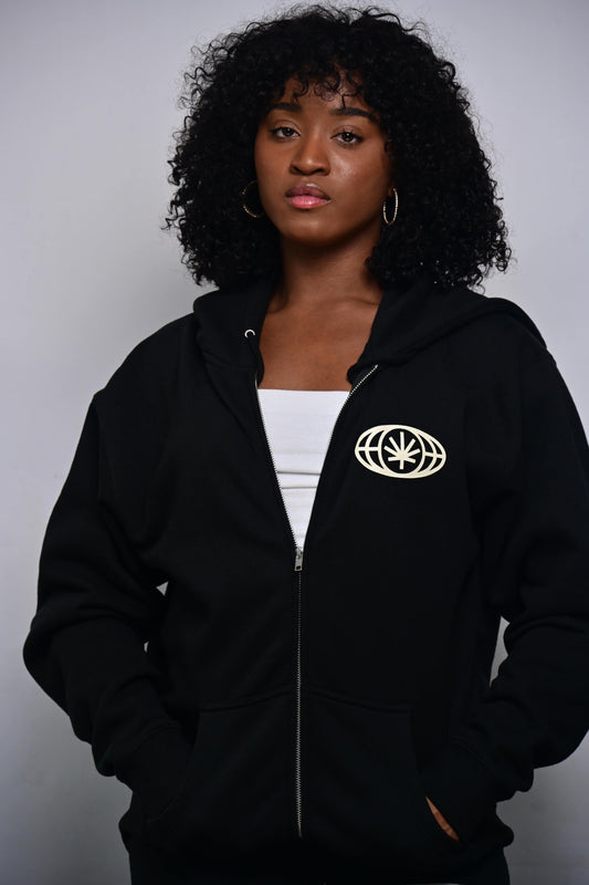 Black zip hoodie with small VYLIN globe icon at left chest (front, on-model)