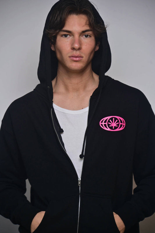 VYLIN black zip hoodie with small hot pink chest emblem (on-model front view)