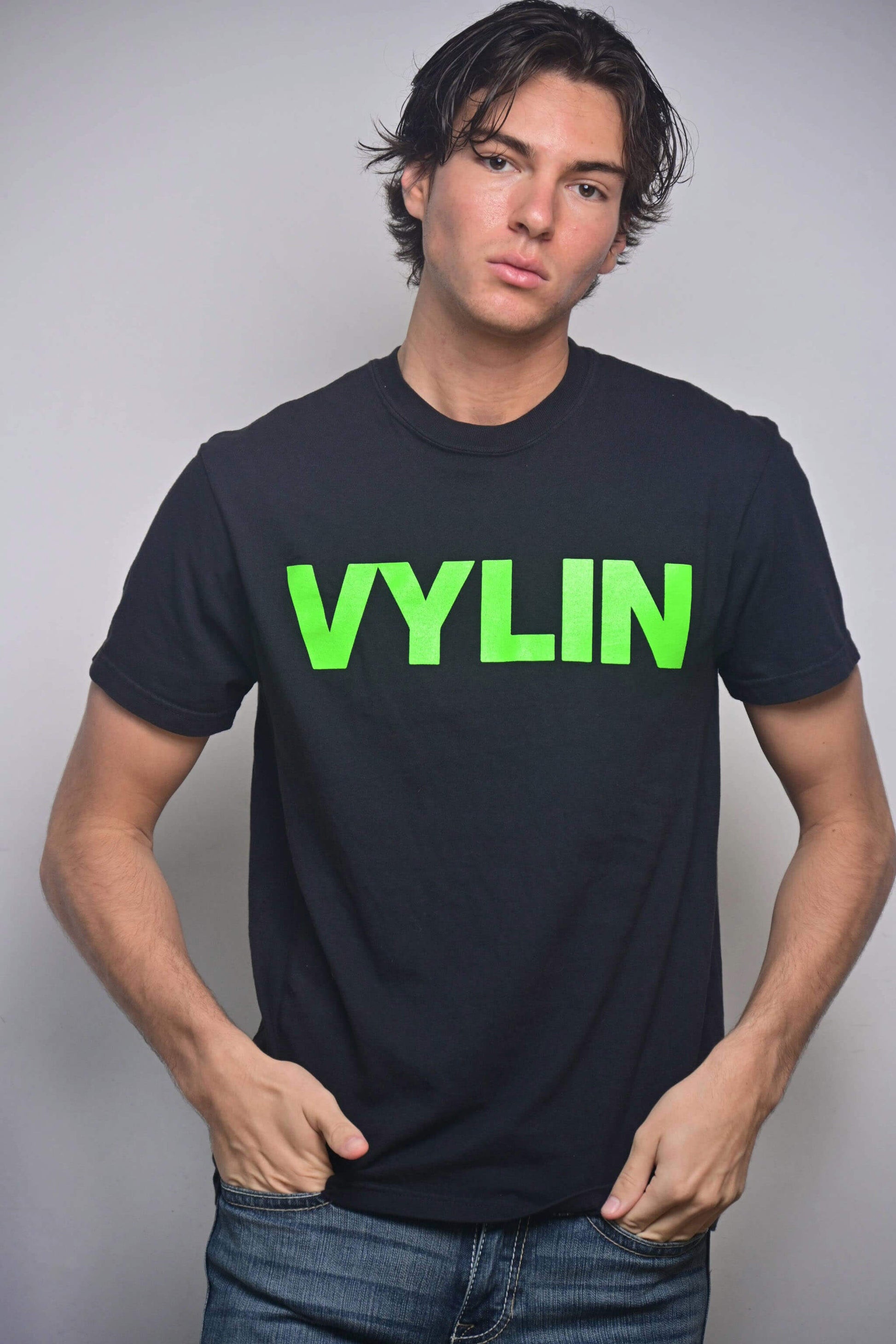 Black tee with acid green VYLIN word mark front graphic (front, on-model)