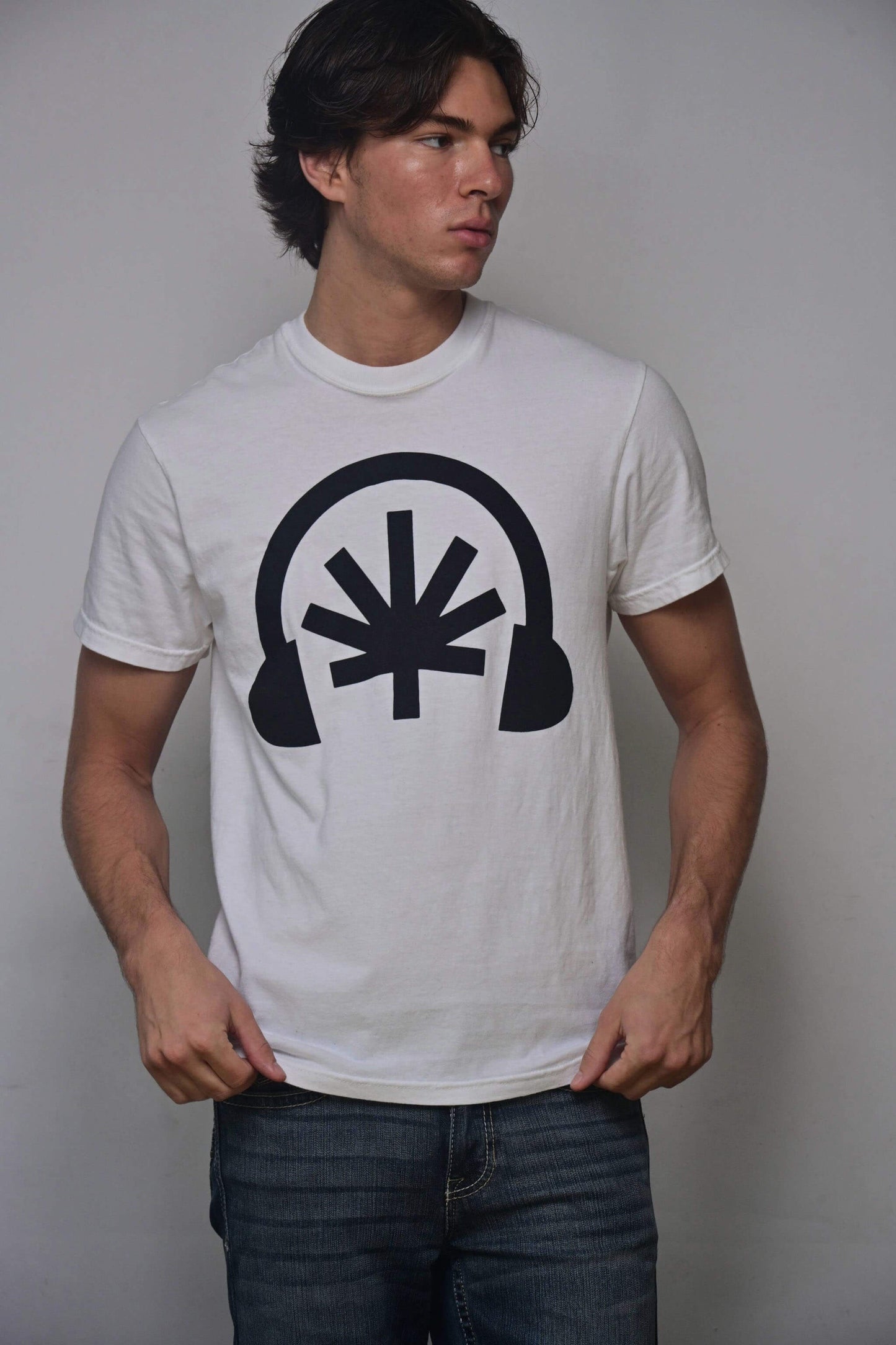 White tee with black Headphones front graphic featuring a stylized cannabis leaf (front, on-model)