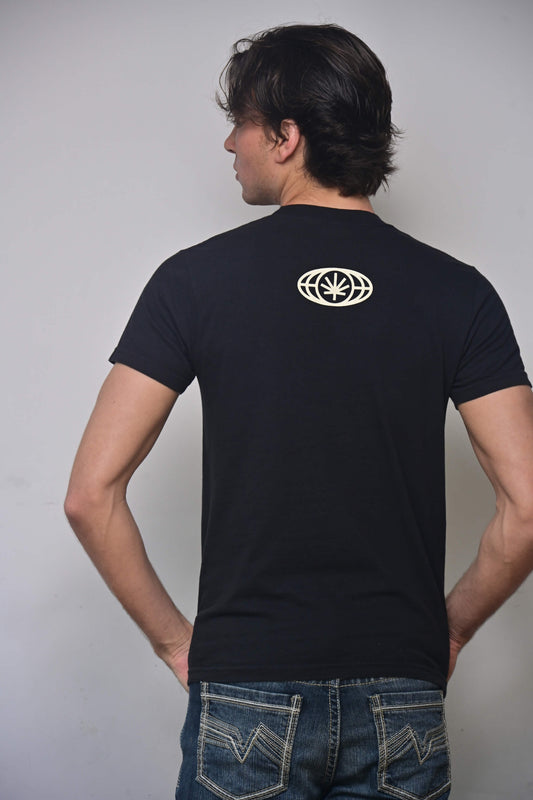 Black tee with small VYLIN globe icon centered ~3 in below back neckline (back, on-model)