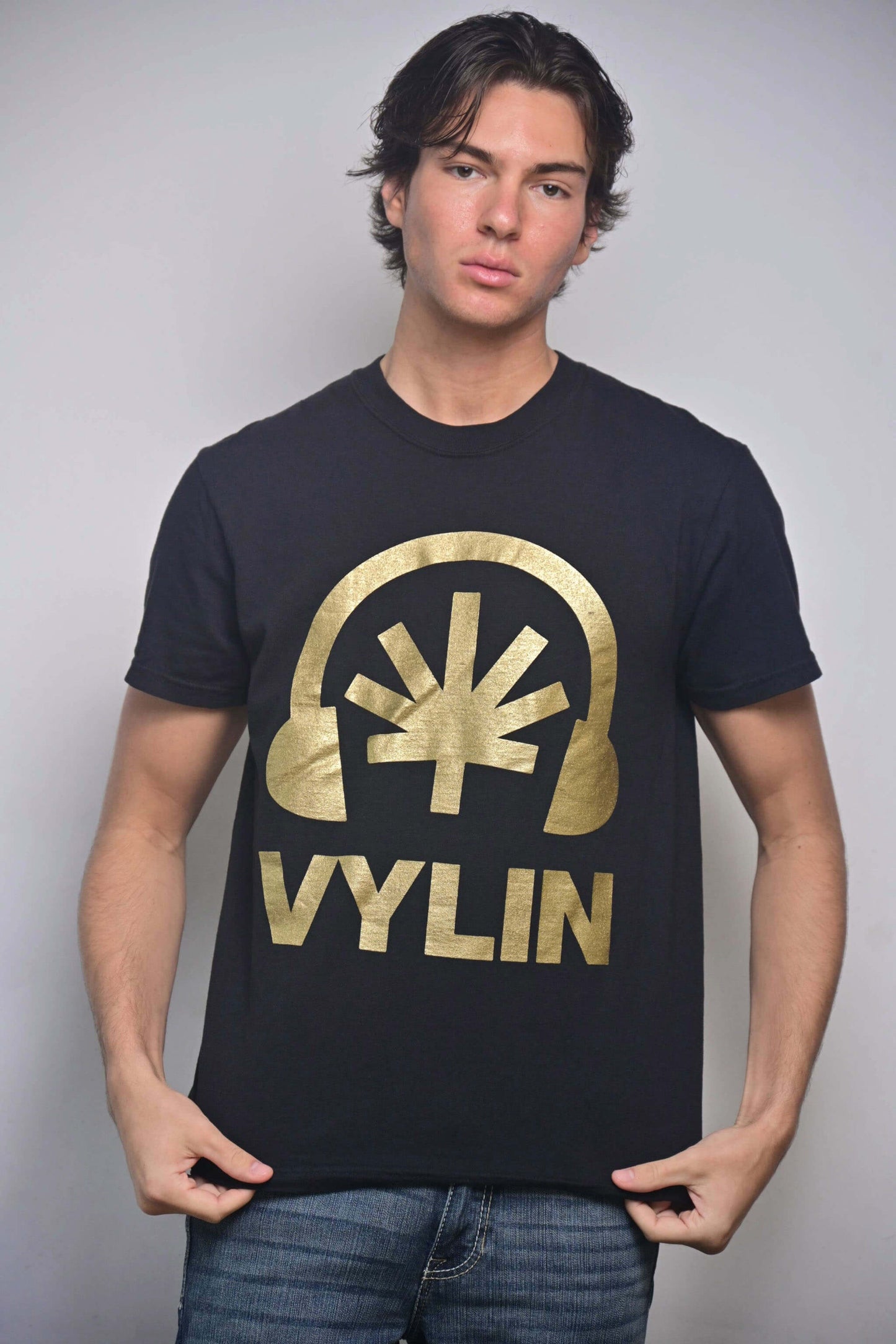 Black tee with gold Headphones + stylized cannabis leaf + VYLIN word mark front composition (front, on-model)